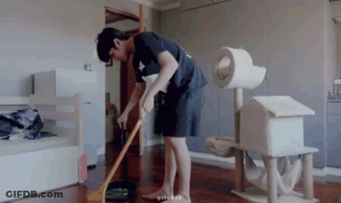 Man Sweeping Floor With Broom In Living Room GIF