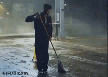 Man Sweeping Floor With Mop And Yellow Safety Cone GIF
