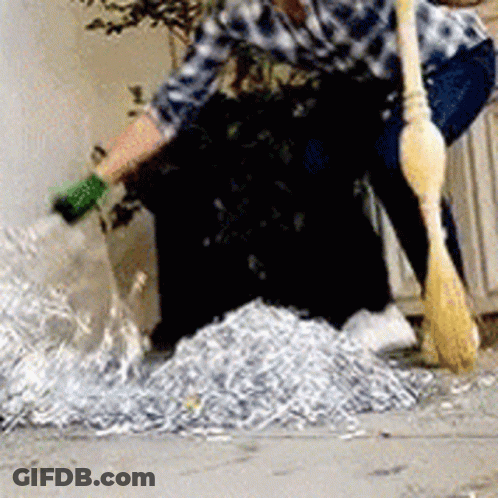 Man Sweeping Shredded Paper GIF