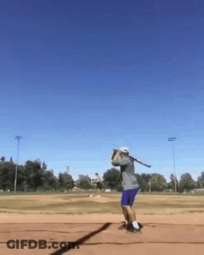 Man Swinging Baseball Bat On Field GIF
