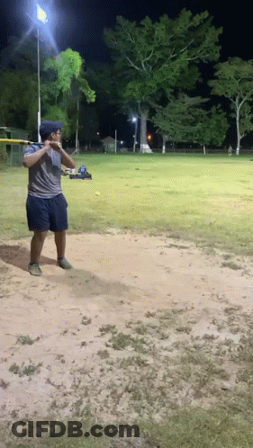 Man Swinging Bat At Ball GIF