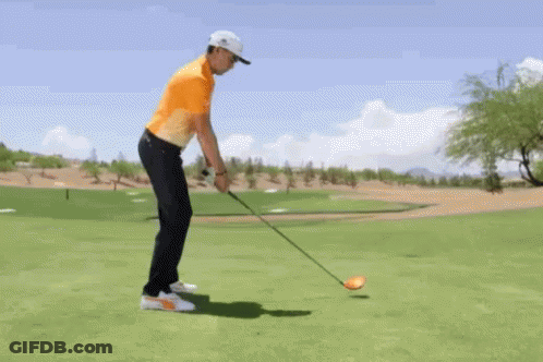 Man Swinging Golf Club At Ball GIF