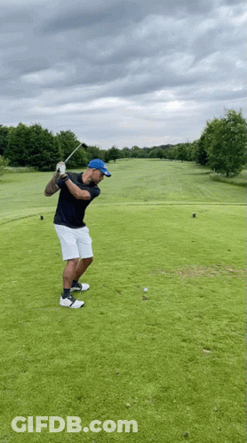 Man Swinging Golf Club At Ball GIF