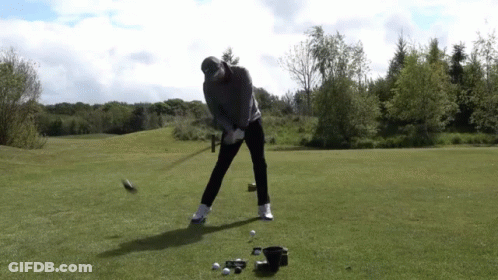 Man Swinging Golf Club At Golf Ball GIF