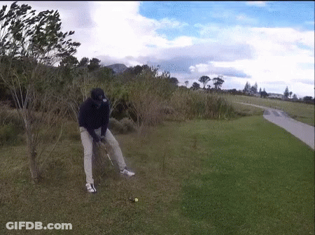 Man Swinging Golf Club At Golf Ball GIF
