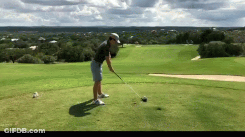Man Swinging Golf Club At Golf Ball GIF