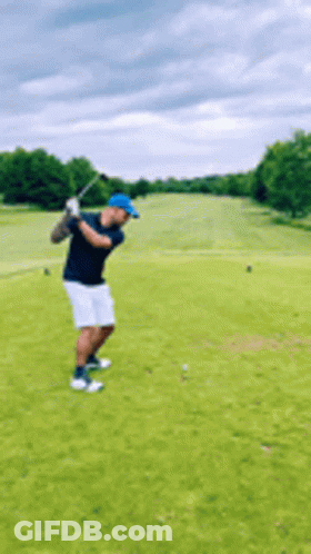 Man Swinging Golf Club At Golf Ball On Golf Course GIF