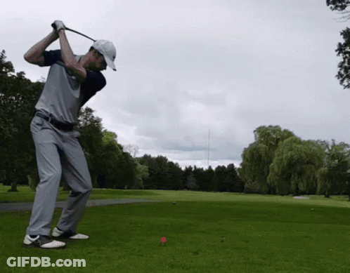 Man Swinging Golf Club At Red Ball GIF