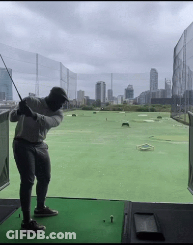 Man Swinging Golf Club City Background GIF