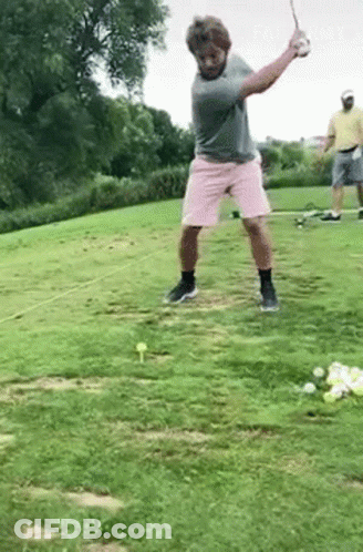 Man Swinging Golf Club In Pink Shorts GIF