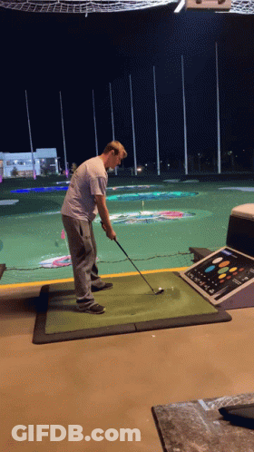 Man Swinging Golf Club GIF