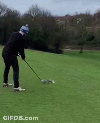 Man Swinging Golf Club On Green Field GIF