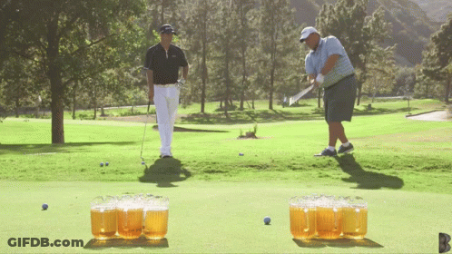 Man Swinging Golf Club While Another Watches GIF