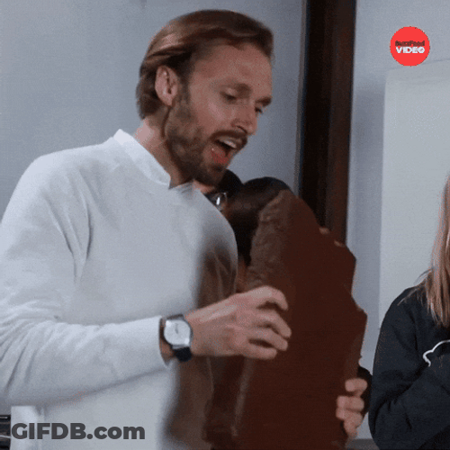 Man Taking Bite On Giant Chocolate Bar GIF