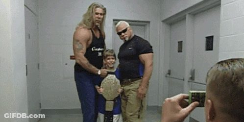 Man Taking Photo Of Wrestlers And Boy With Belt GIF