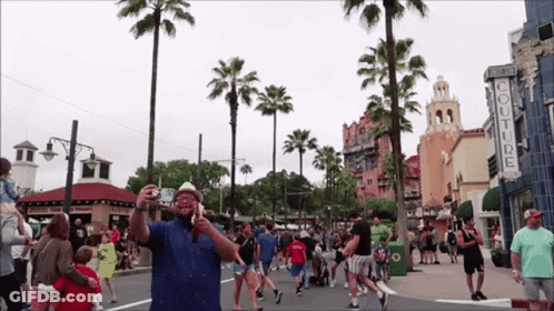 Man Taking Picture At Couture Store GIF