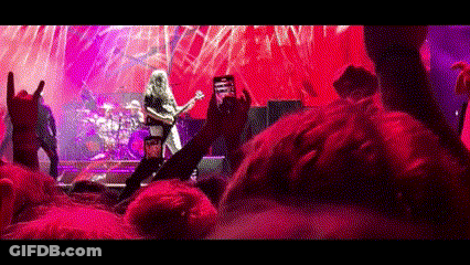 Man Taking Picture Of Band On Stage GIF