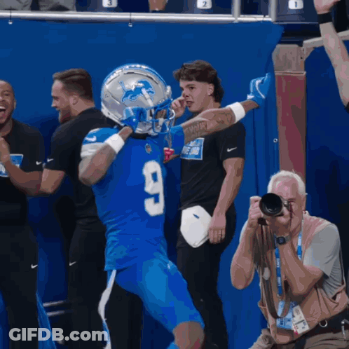 Man Taking Picture Of Football Player In Number 9 Jersey GIF