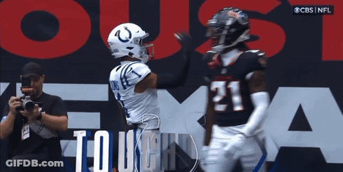 Man Taking Picture Of Football Player Number 21 GIF