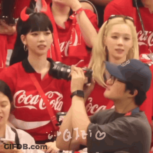 Man Taking Picture Of Girl In Red Coca Cola Shirt GIF
