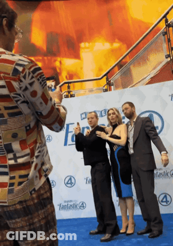 Man Taking Picture Of Group On Fantastic 4 Blue Carpet GIF