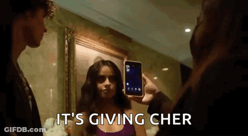 Man Taking Picture Of Woman With It's Giving Cher GIF