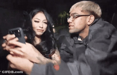 Man Taking Picture Of Woman With Phone GIF