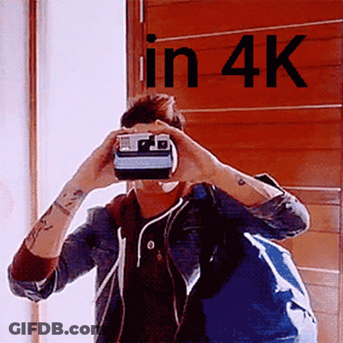 Man Taking Picture With Polaroid Camera In 4K GIF