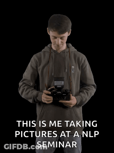 Man Taking Pictures At NLP Seminar With Arms Outstretched GIF