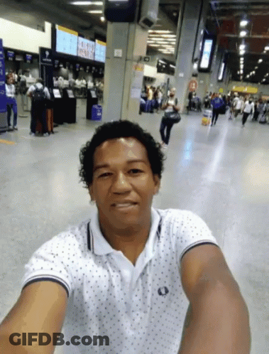 Man Taking Selfie At Airport With Aeroporto Sign GIF