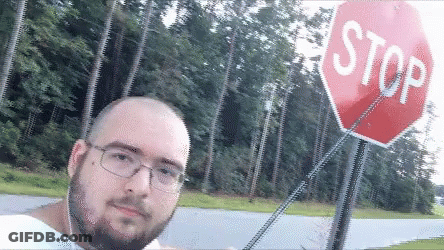 Man Taking Selfie In Front Of Stop Sign GIF