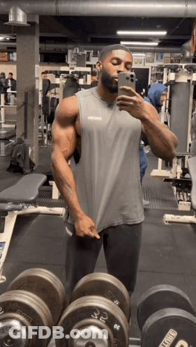 Man Taking Selfie In Gym With King Dumbbells GIF