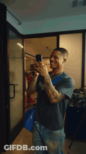 Man Taking Selfie In Mirror With Phone GIF