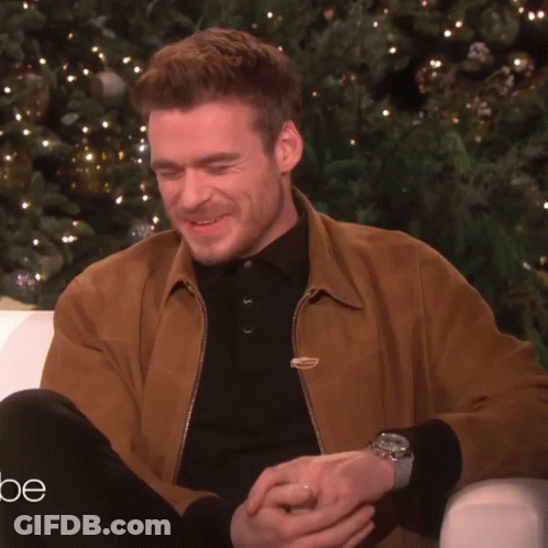 Man Talking In Front Of Christmas Tree GIF