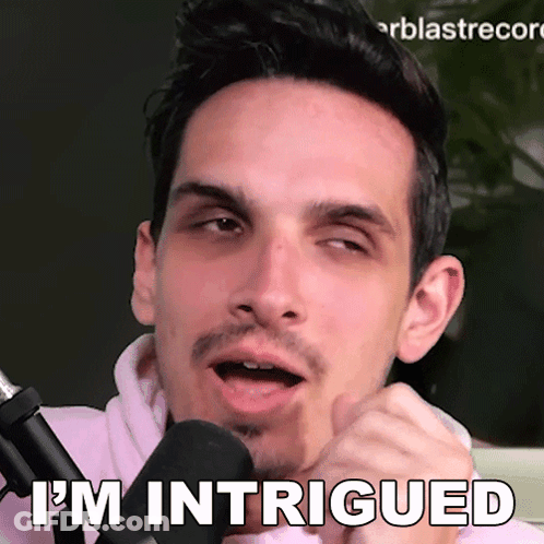 Man Talking Into Mic Saying I'm Intrigued GIF