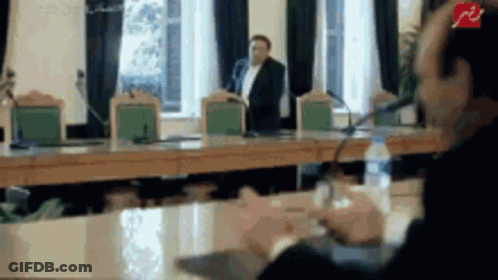 Man Talking Into Microphone, Another Behind GIF