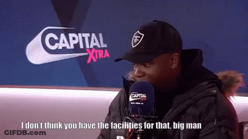 Man Talking Into Microphone In Front Of Capital Xtra Logo GIF