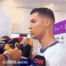 Man Talking Into Microphone In White Shirt GIF
