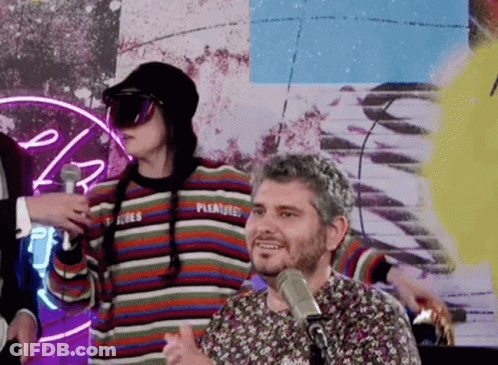 Man Talking Into Microphone Wearing Pleasure Sweater GIF