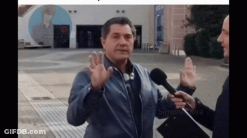 Man Talking Into Microphone With Simone Kira Poster GIF