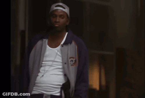 Man Talking On Cell Phone Behind Fence GIF