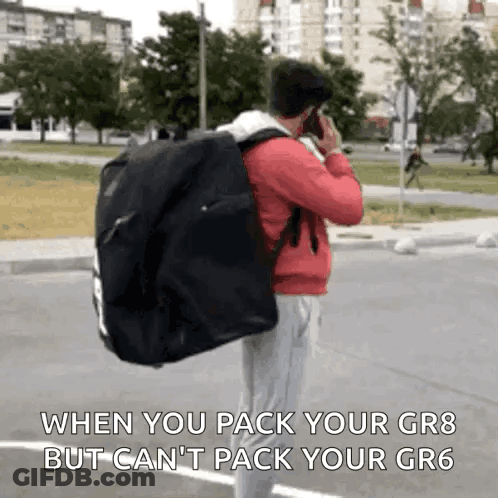 Man Talking On Cell Phone Carrying Bag GIF
