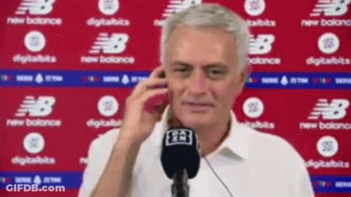 Man Talking On Cell Phone In Front Of New Balance Sign GIF