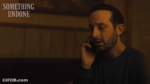 Man Talking On Cell Phone With Something Undone GIF