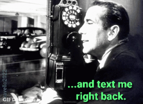 Man Talking On Pay Phone Saying Text Me Right Back GIF