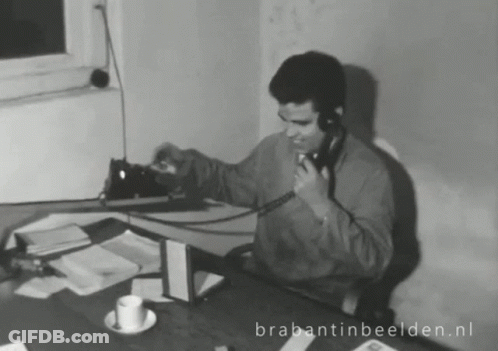 Man Talking On Phone At Desk Brabantinbeelden.nl GIF