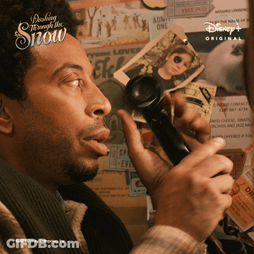 Man Talking On Phone Dash Through The Snow GIF