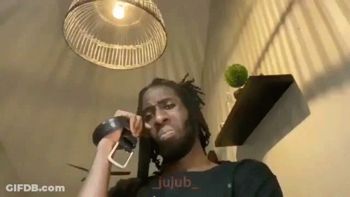Man Talking On Phone With Belt Around Neck GIF