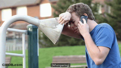 Man Talking On Phone With Cone Over Face GIF