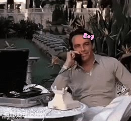 Man Talking On Phone With Hello Kitty Bow On Forehead GIF